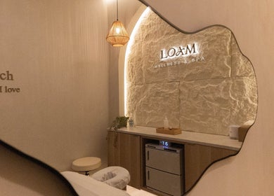 Elegant interior of LOAM Wellness & Spa, Las Vegas, Nevada, US with soft lighting and rustic decor.