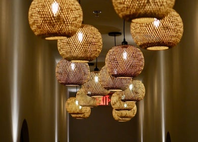 Warm woven pendant lights adorn the chic hallway of LOAM Wellness & Spa in Las Vegas, Nevada, US.