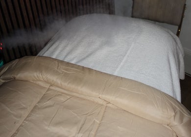 Relaxing treatment bed at HOUSE OF GOLD, Monifieth, Scotland, GB, with steam mist for a rejuvenating experience.