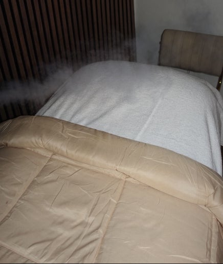 Relaxing treatment bed at HOUSE OF GOLD, Monifieth, Scotland, GB, with steam mist for a rejuvenating experience.