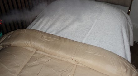Cozy massage table setup with steam at HOUSE OF GOLD, Monifieth, Scotland, GB for ultimate relaxation.