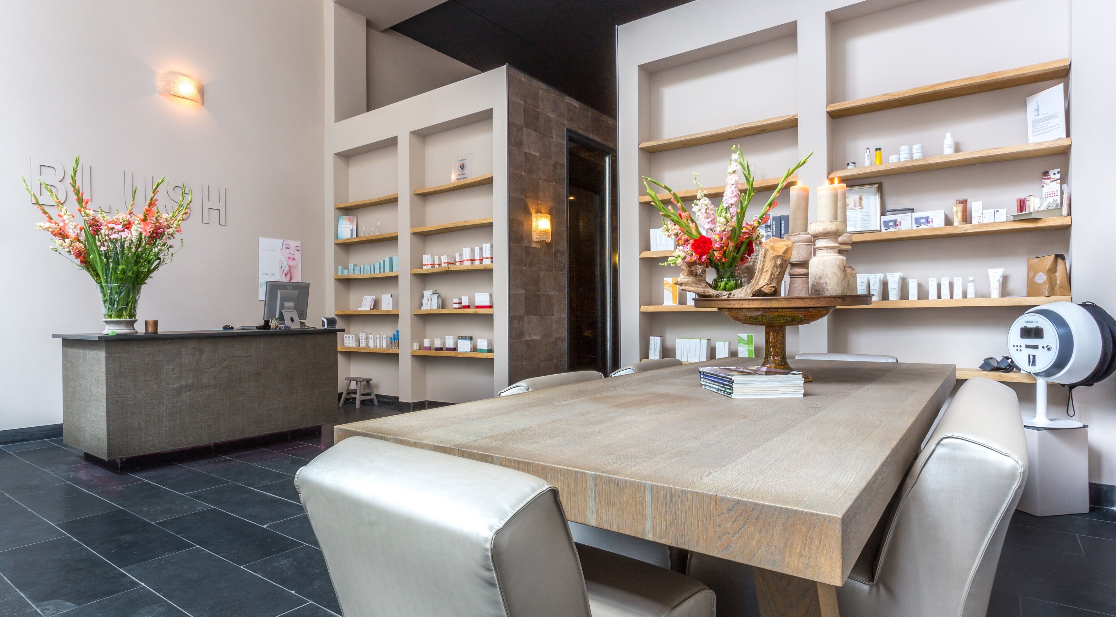 Chic interior of BLUSH Beauty & Skin Clinic, Zuidas in Amsterdam, Noord-Holland, NL, featuring elegant decor and skincare products.