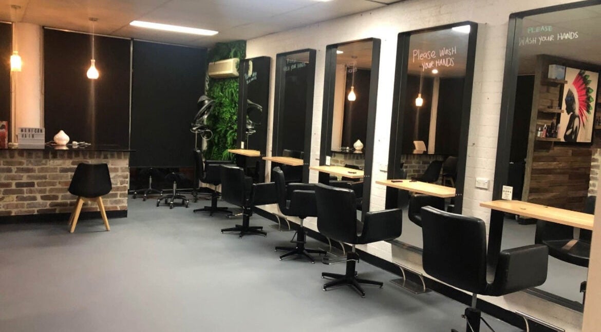 Modern interior of Blondes & Blowouts Tuggerah, featuring stylish black chairs and large mirrors in Tuggerah, New South Wales, AU.