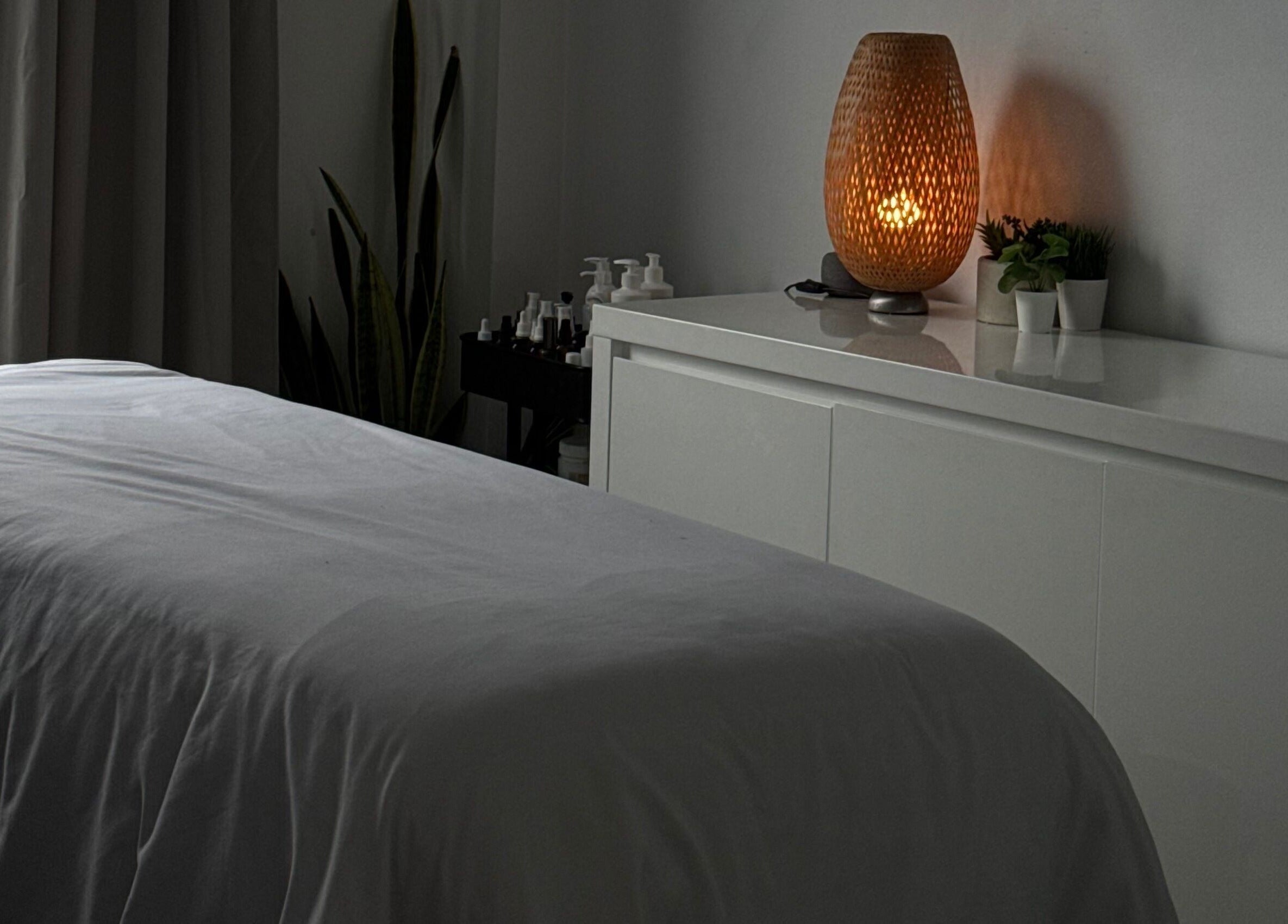 Cozy treatment room at The Brandy Alexander, Whitby, Ontario, CA, featuring a softly lit lamp.