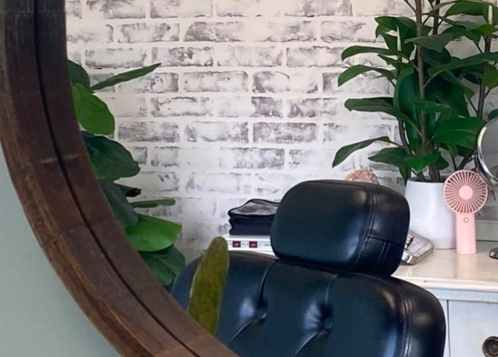 Elegant salon chair with mirror and plants at The Brandy Alexander, Whitby, Ontario, CA.