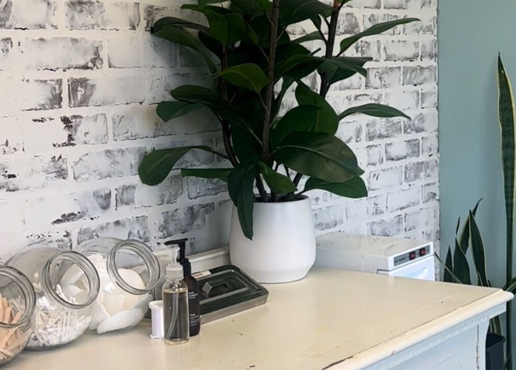 Cozy corner at The Brandy Alexander with plants and essentials in Whitby, Ontario, CA.