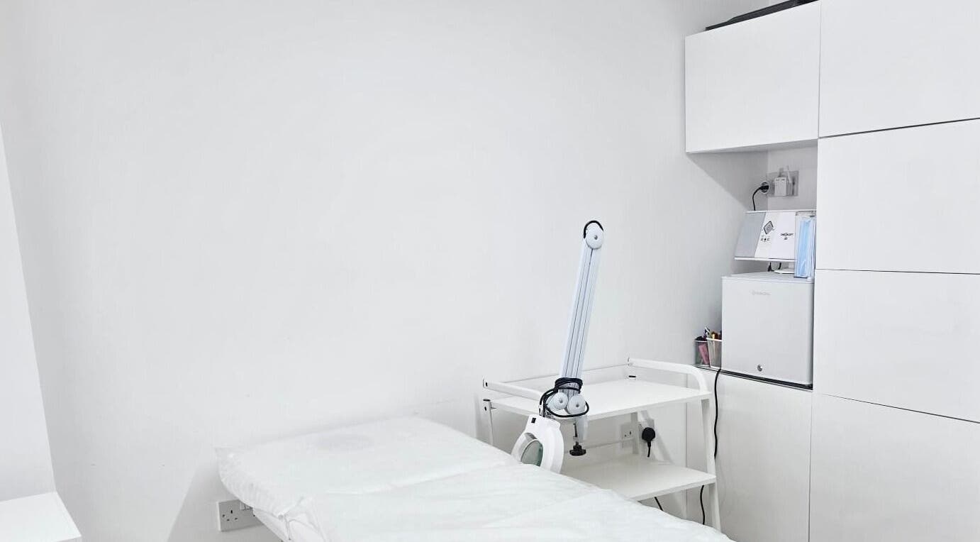 Clean, minimal treatment room at Riana Aesthetics - Luton, Luton, England, GB. Features a treatment bed and equipment.