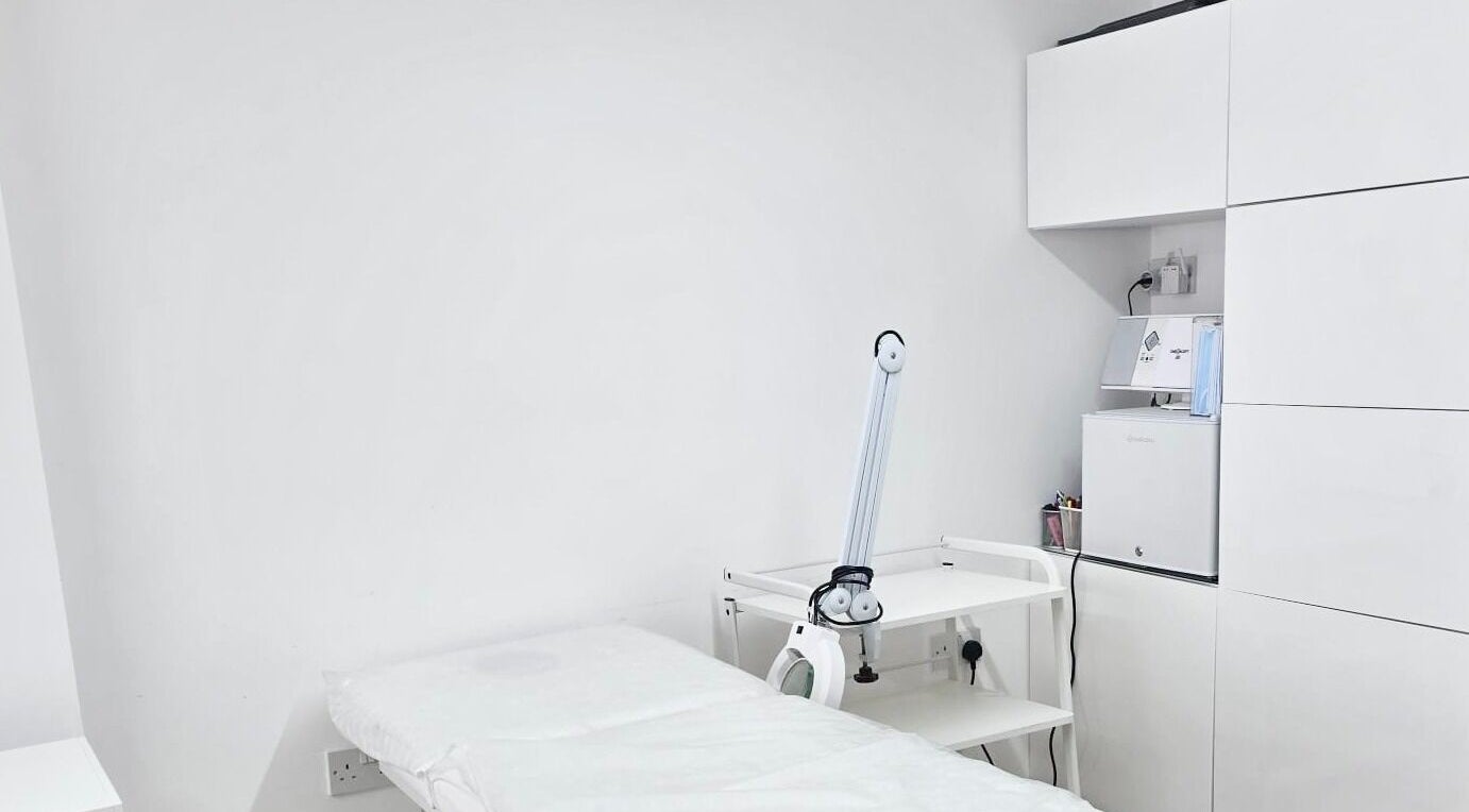 Clean, minimal treatment room at Riana Aesthetics - Luton, Luton, England, GB. Features a treatment bed and equipment.