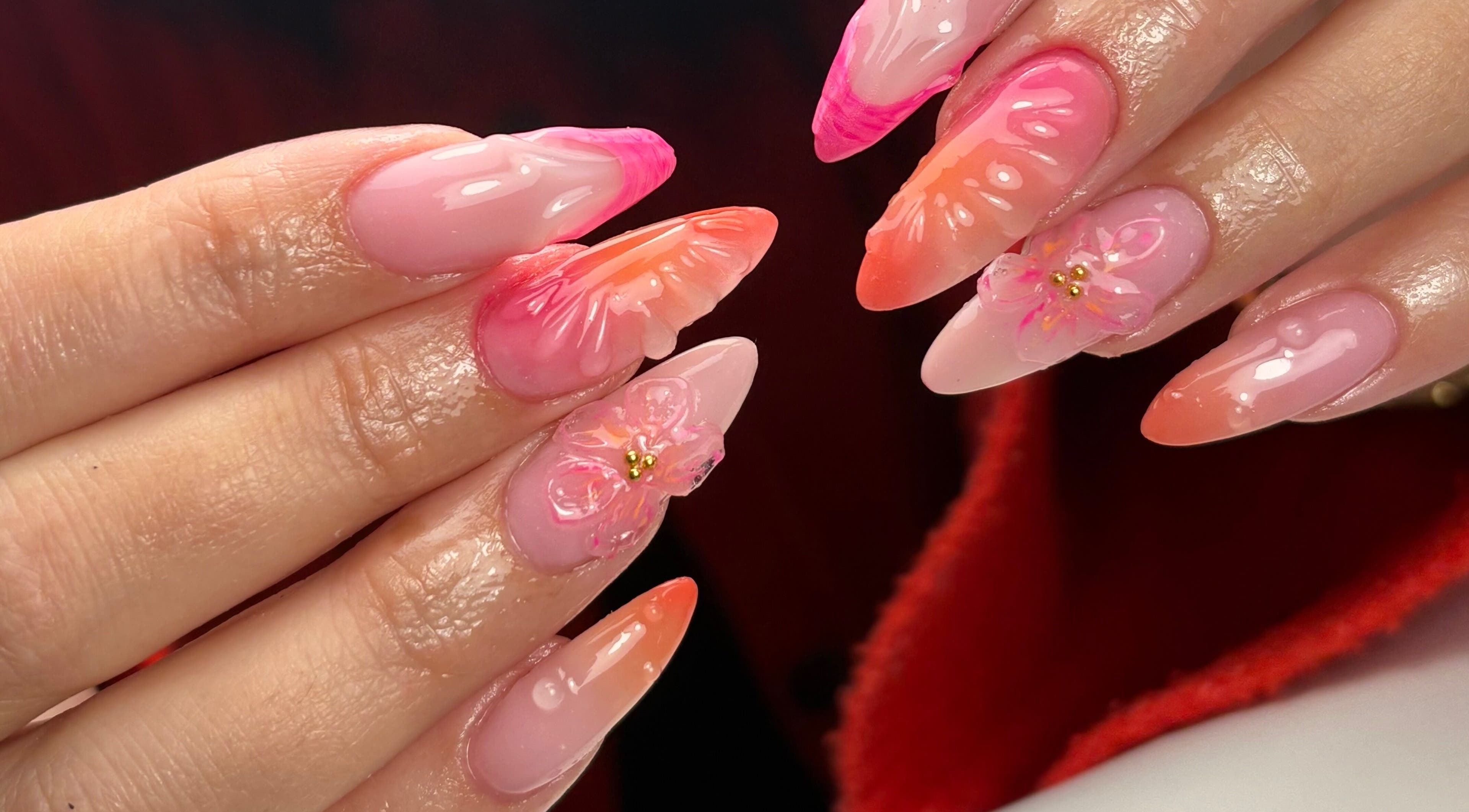 Stylish floral acrylic nails by ALH Beauty, Wishaw, Scotland, GB, showcasing vibrant pink and orange hues.