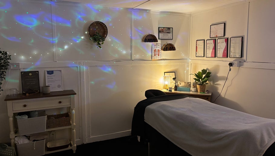 Tranquil massage room at Shell Mckee Wellness, Northwich, England, GB with decorative lighting and wall art.