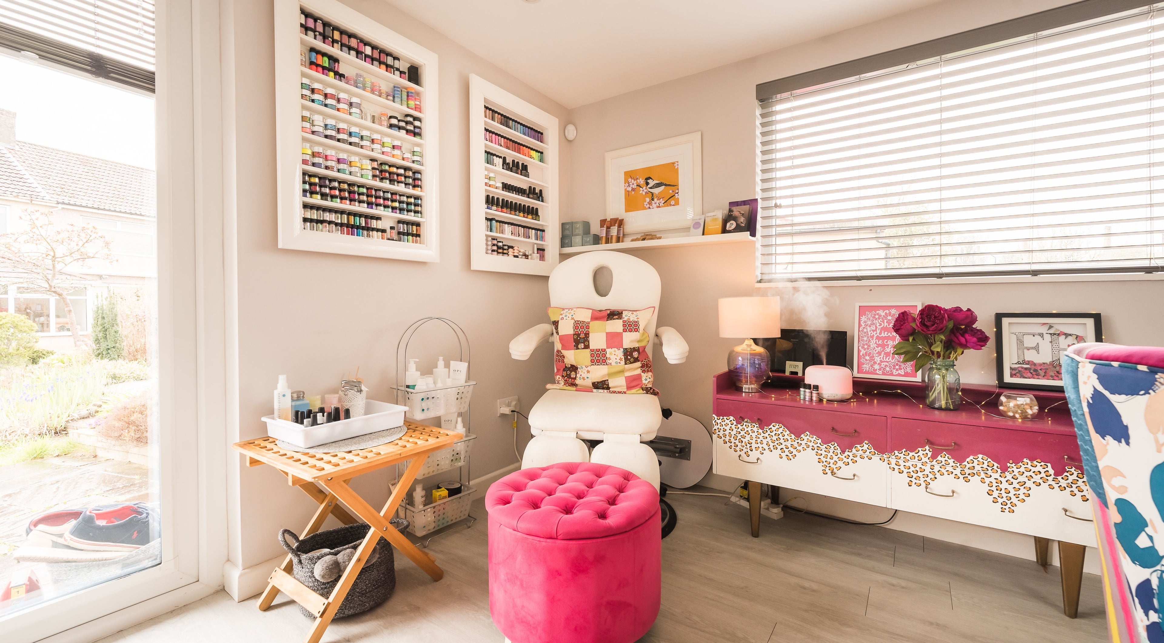 Fuchsia Beauty Bristol, England, GB nail salon corner with plush pink seating and organized polish display.