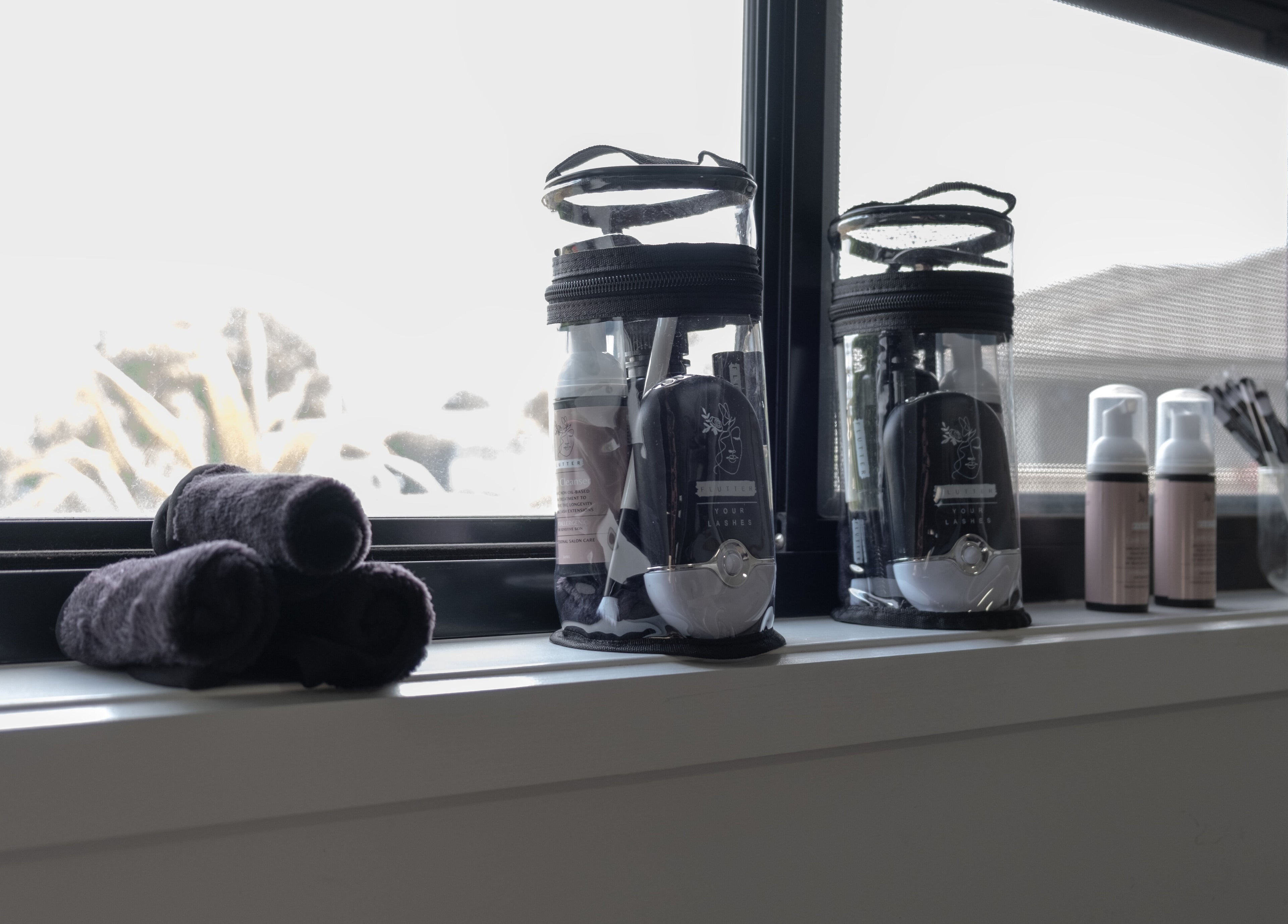 Beauty tools and products on a windowsill at Flutter Your Lashes, Redland Bay, Queensland, AU.