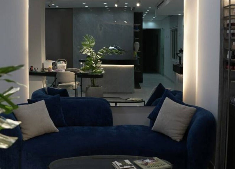 Elegant interior of Gloss'd Beauty Bar in Amman, JO, featuring cozy seating and modern decor.