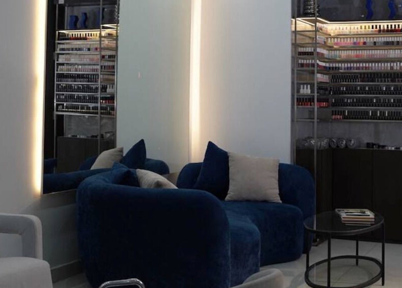 Luxurious seating and nail polish display at Gloss'd Beauty Bar, Amman, Amman Governorate, JO.