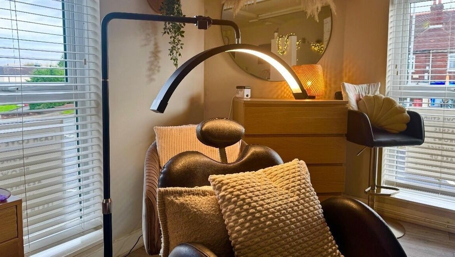 Comfortable lash chair setup at Lash Love Faye, Birkenhead, England, GB with warm lighting and cushions.