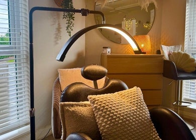 Comfortable lash chair setup at Lash Love Faye, Birkenhead, England, GB with warm lighting and cushions.