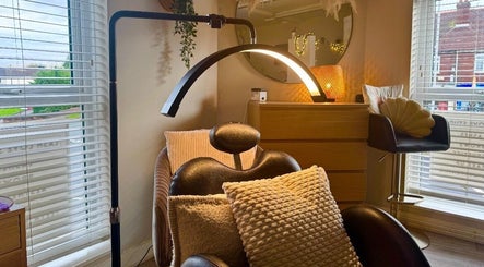 Comfortable lash chair setup at Lash Love Faye, Birkenhead, England, GB with warm lighting and cushions.