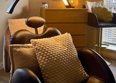 Relaxing chair with cushions at Lash Love Faye, Birkenhead, England, GB. Perfect for comfort and wellness.