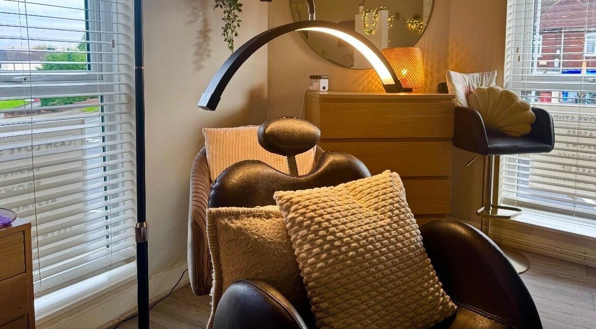 Relaxing treatment room at Lash Love Faye in Birkenhead, England, GB, featuring a plush chair and warm lighting.