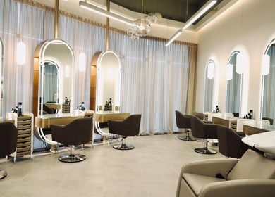 Stylish interior at Nado Salon in Sharjah, Sharjah, AE showcasing chic chairs and modern design.