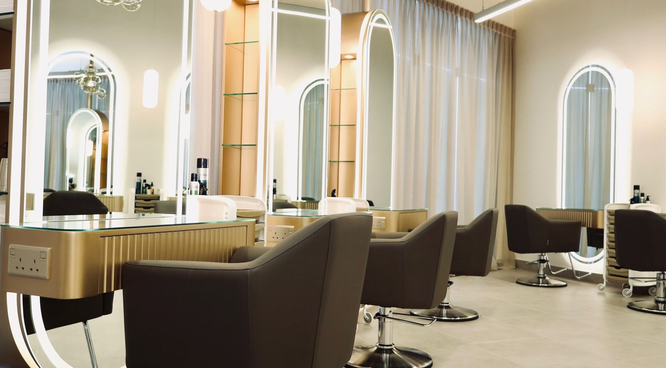 Elegant salon interior at Nado Salon, Sharjah, AE with mirrored stations and stylish seating.