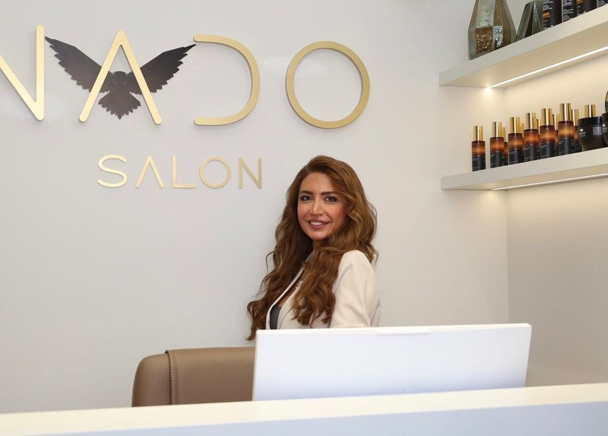 Nado Salon reception with welcoming staff in Sharjah, Sharjah, AE, showcasing beauty products.