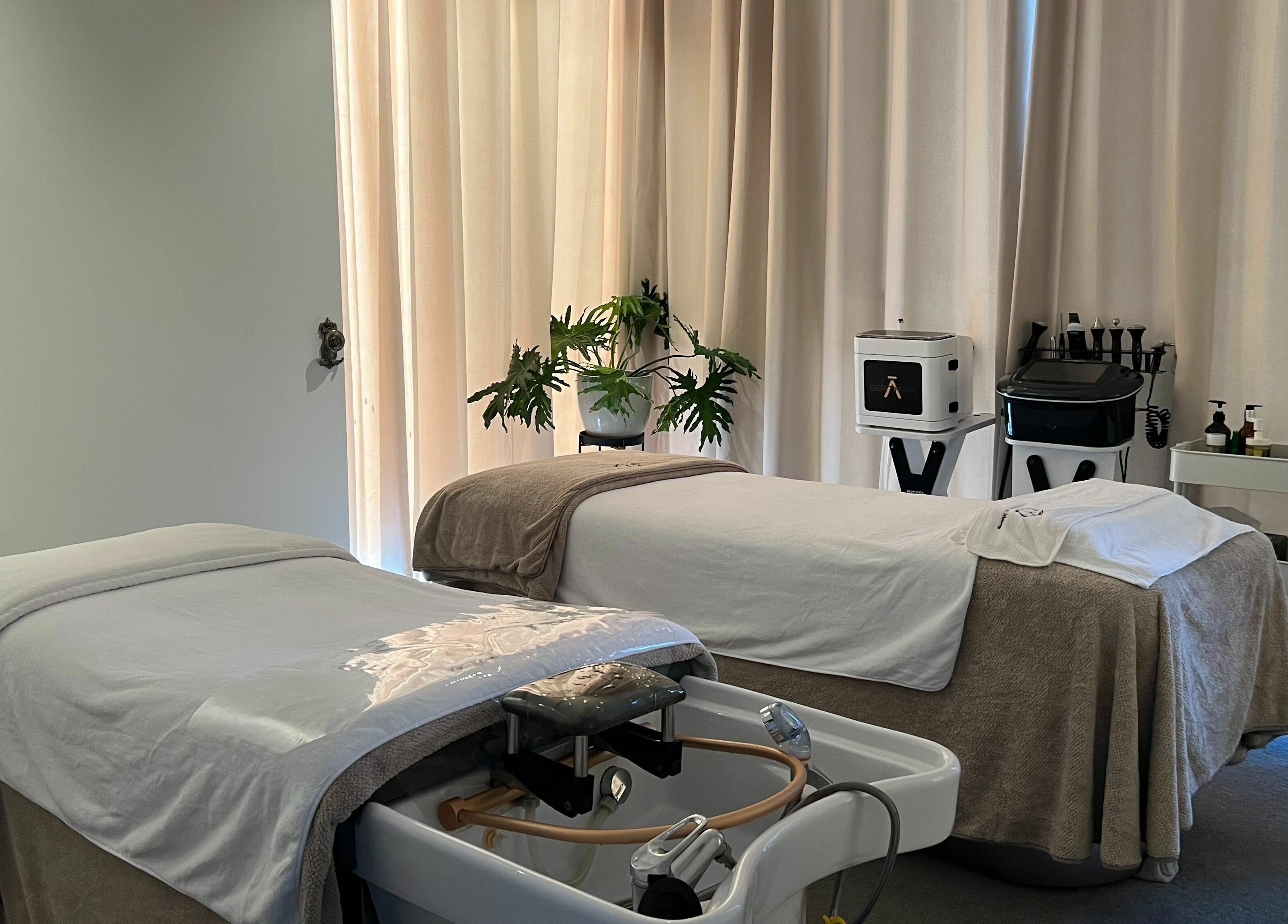 Calming massage room at Young Beauty Massage, Claremont, Western Australia, AU with two beds and soft lighting.