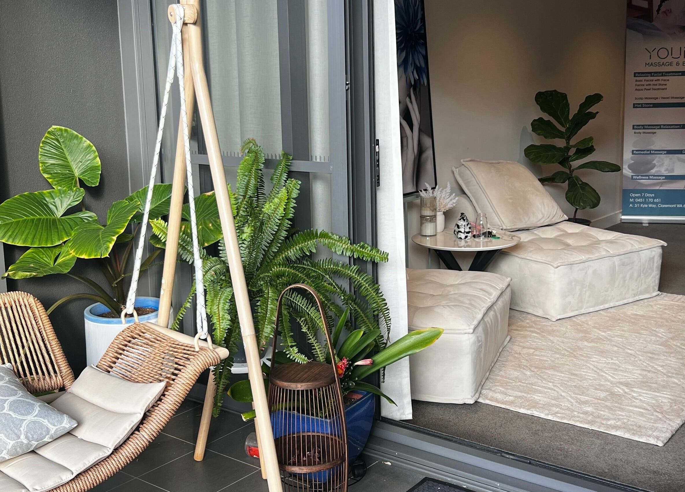 Relaxing seating area at Young Beauty Massage in Claremont, Western Australia, AU, showcasing lush greenery.