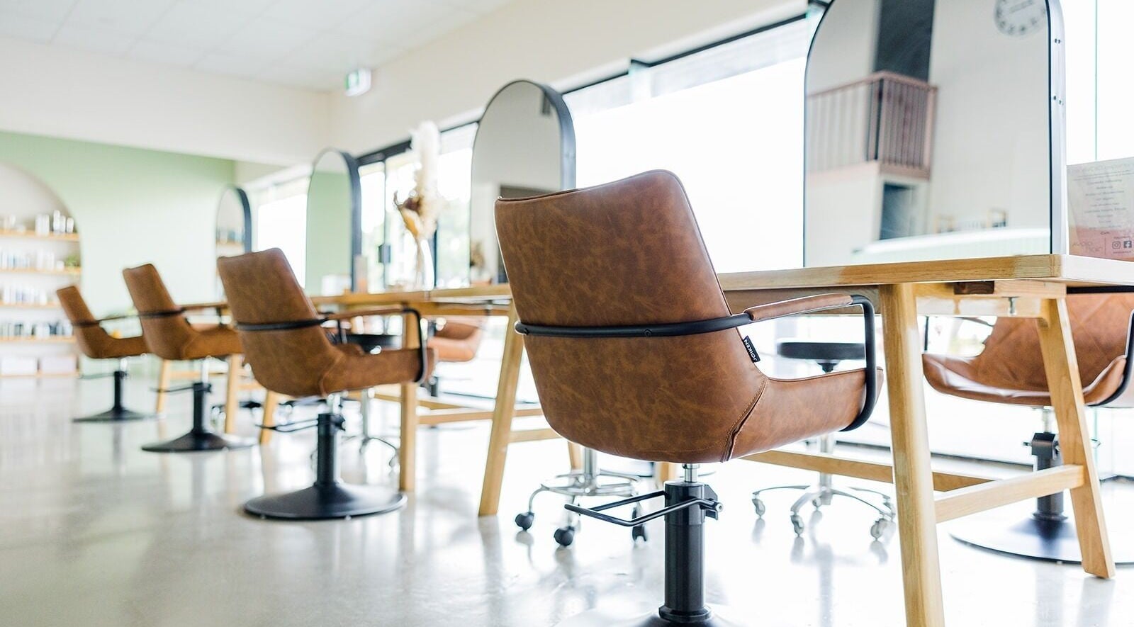 Modern salon interior with leather chairs at Avaia Hair, Mackay, QLD, AU, offering stylish ambience and comfort.