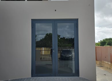 Sleek blue doors at Bonaire Beauty By X, Kralendijk, Bonaire, BQ offering a welcoming entry.