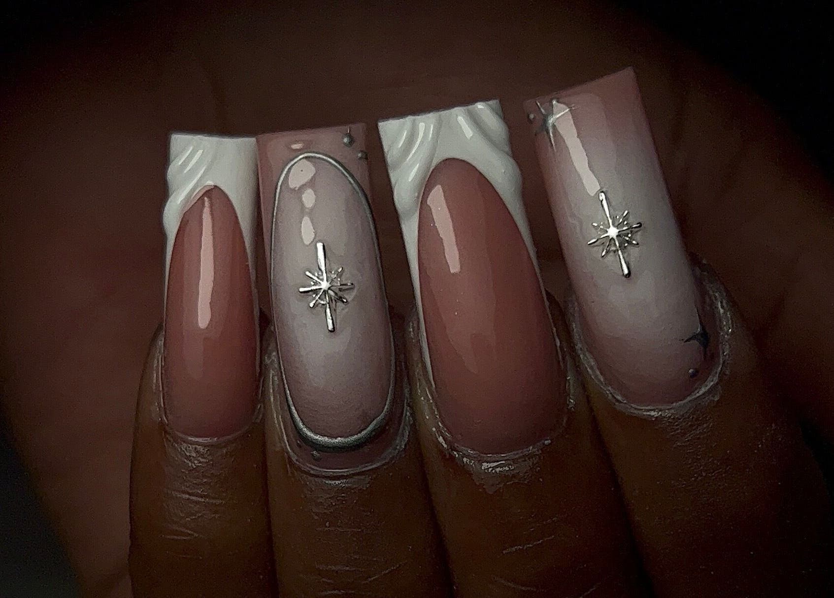 Elegant nail art with stars at DCE Care in Willemstad, Curaçao, CW highlights premium manicure service.