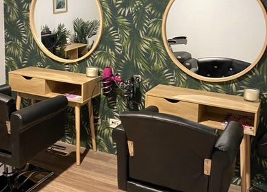 Stylish salon chairs at Melissa Ann HAIR STUDIO in Wandi, Western Australia, AU with lush green decor.