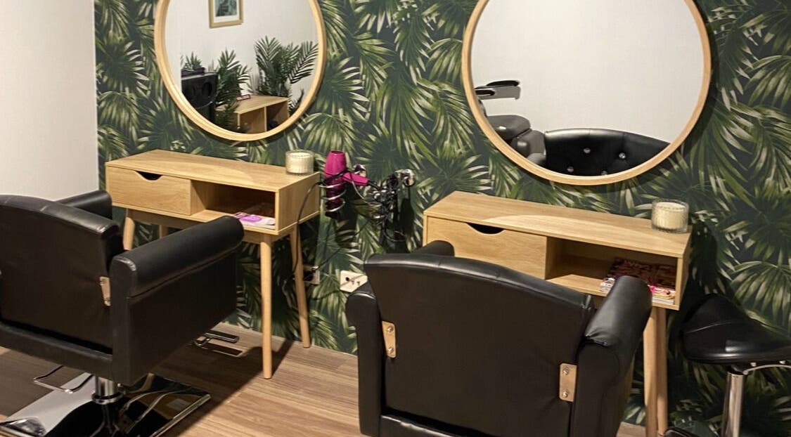 Stylish salon chairs at Melissa Ann HAIR STUDIO in Wandi, Western Australia, AU with lush green decor.