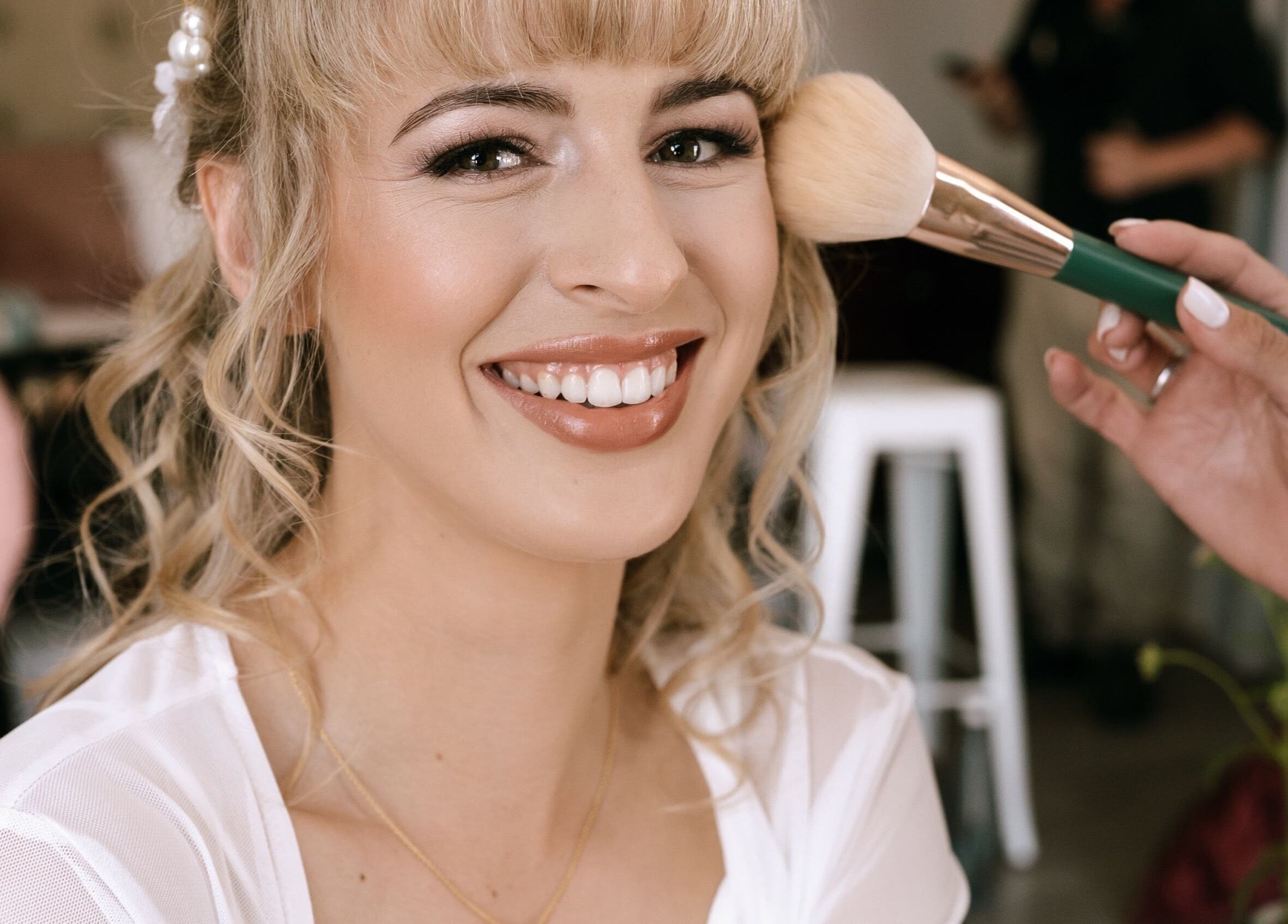 Smiling woman getting makeup at Angelic Aesthetics in Cape Town, Western Cape, ZA.