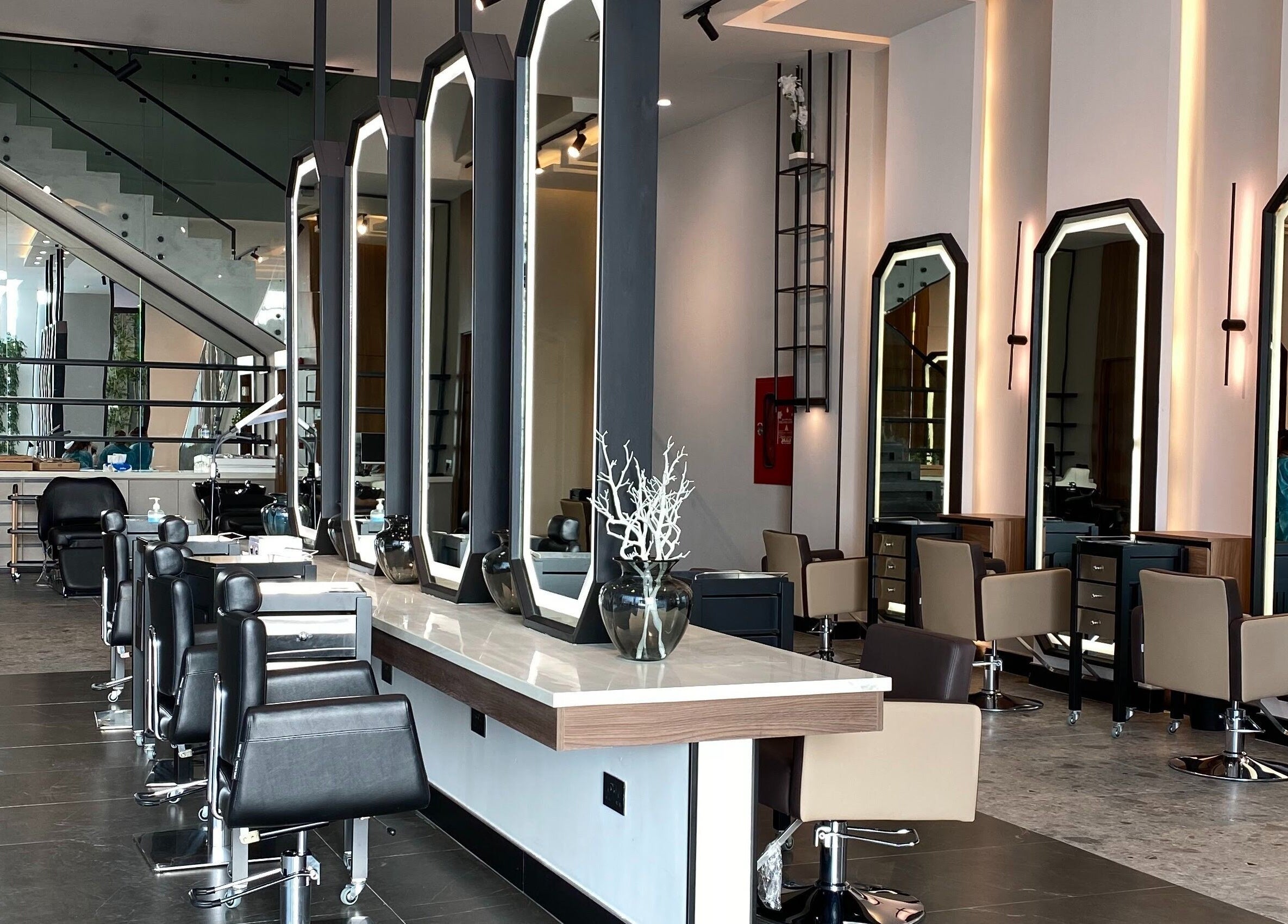 Modern salon interior at Fayzacenter, Riyadh, Riyadh Province, SA, featuring sleek styling stations.