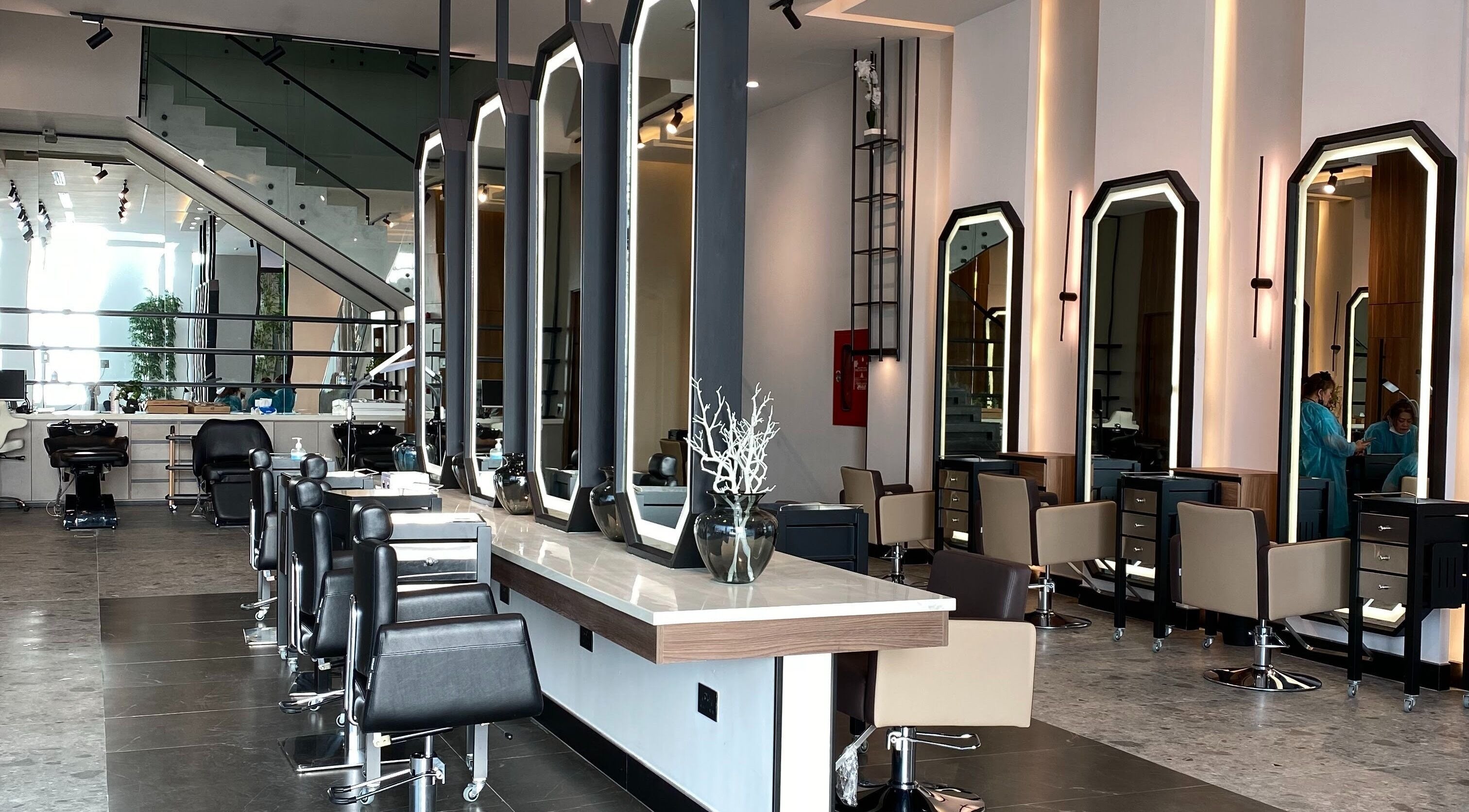 Modern salon interior at Fayzacenter, Riyadh, Riyadh Province, SA, featuring sleek styling stations.