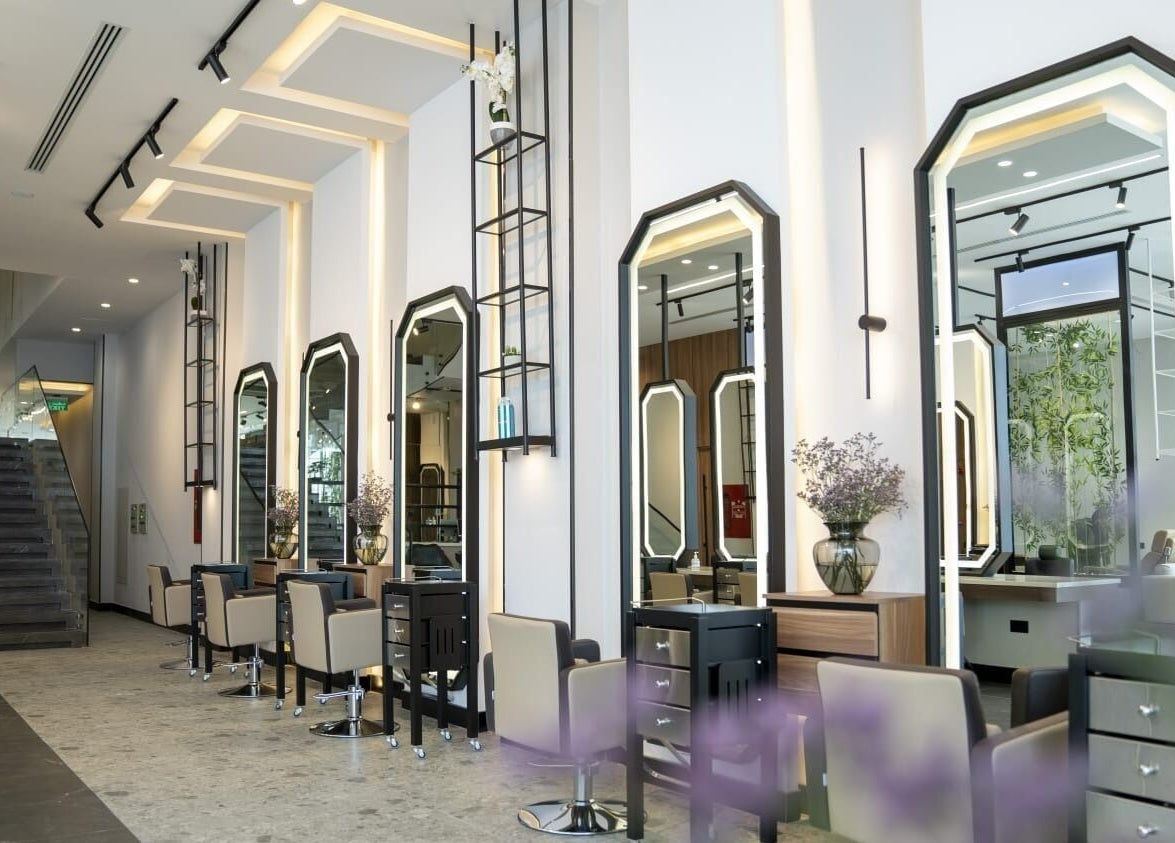 Elegant salon interior at Fayzacenter, Riyadh, Riyadh Province, SA with stylish mirrors and chairs.