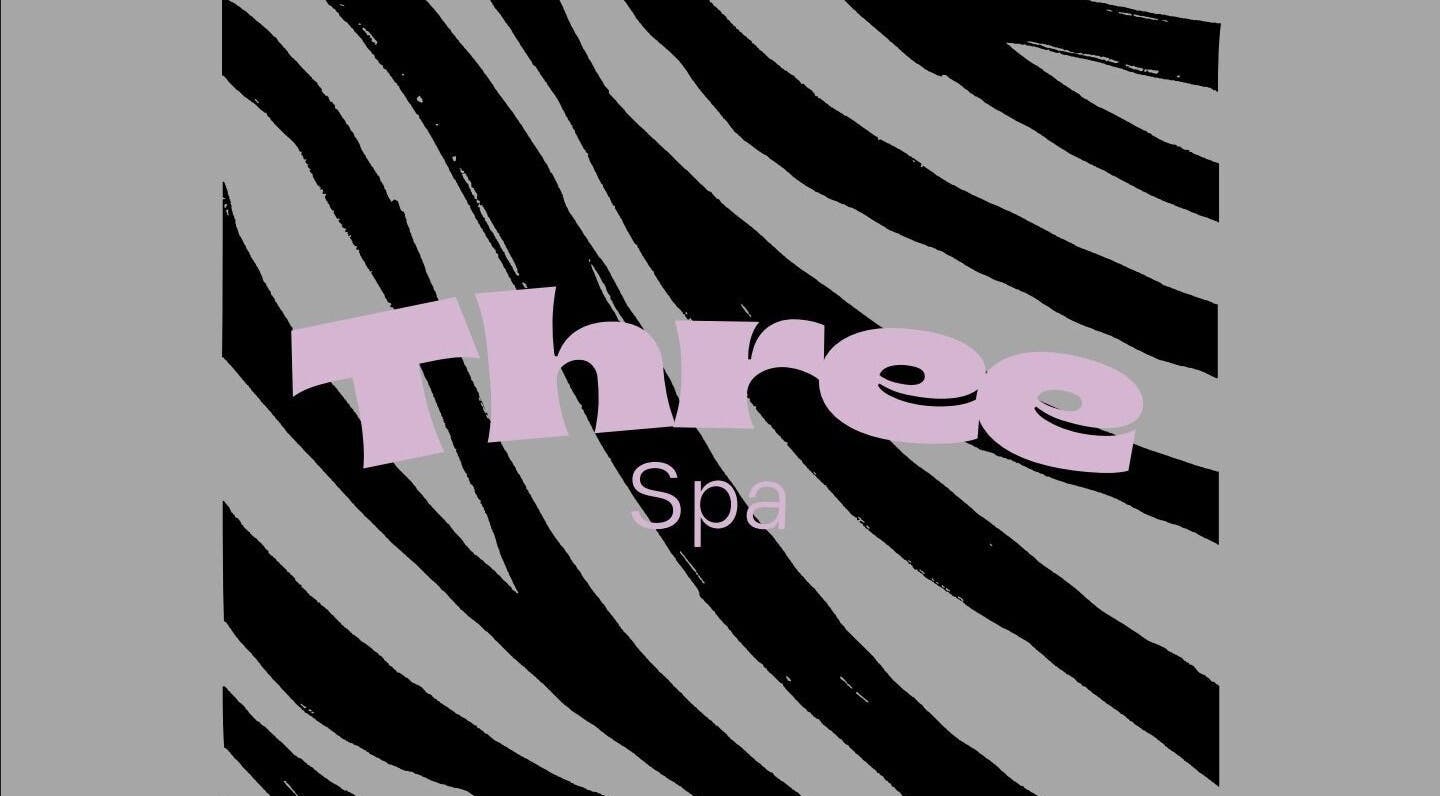 Three Spa logo on zebra pattern background in Doha, QA, showcasing luxury wellness ambiance.