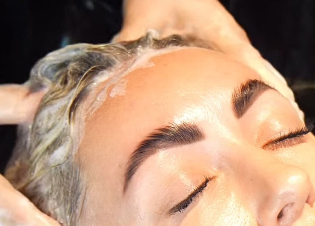 Woman enjoying a luxurious hair wash at PAFOS, Dubai, Dubai, AE, highlighting serene relaxation.