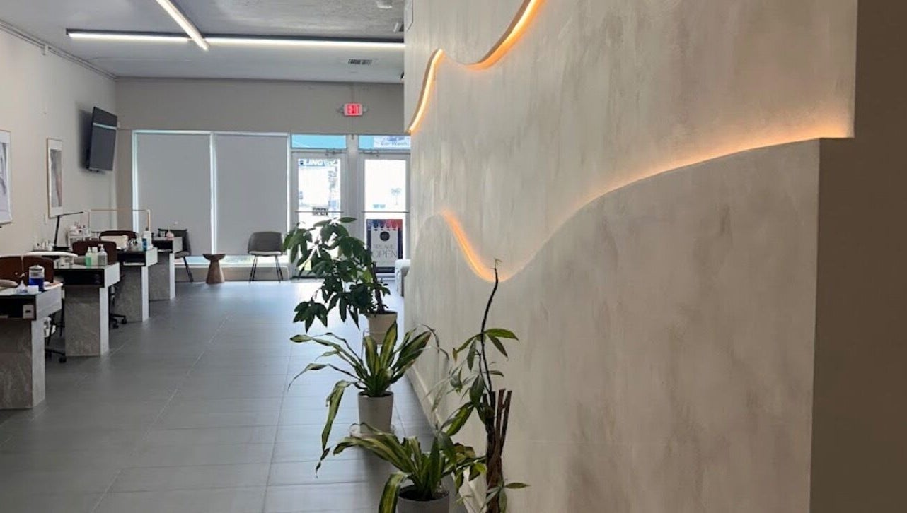 Modern interior of Dipp’d Nail Lounge in Hallandale Beach, Florida, US, showcasing stylish decor and greenery.