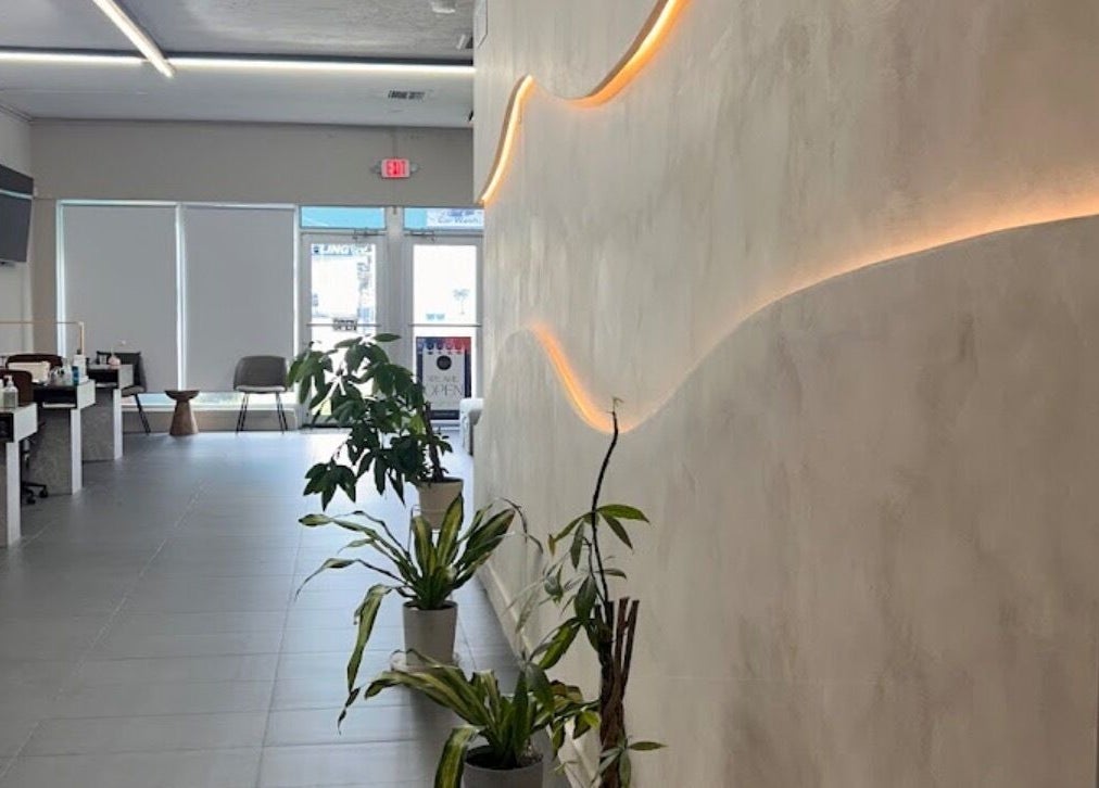 Modern interior of Dipp’d Nail Lounge in Hallandale Beach, Florida, US, showcasing stylish decor and greenery.