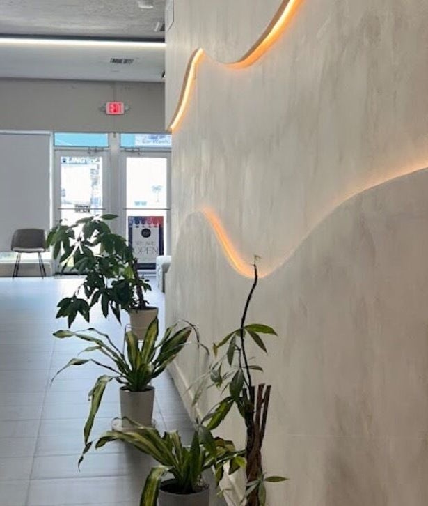 Modern interior of Dipp’d Nail Lounge in Hallandale Beach, Florida, US, showcasing stylish decor and greenery.