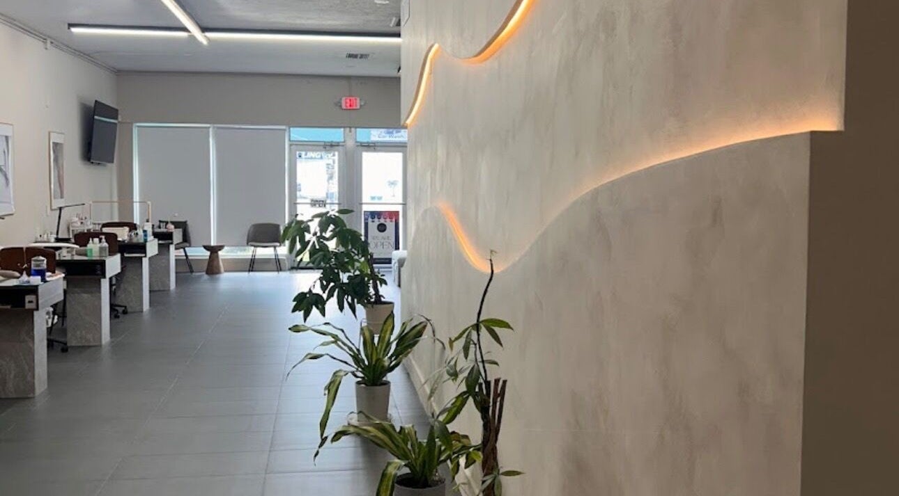 Modern interior of Dipp’d Nail Lounge in Hallandale Beach, Florida, US, showcasing stylish decor and greenery.