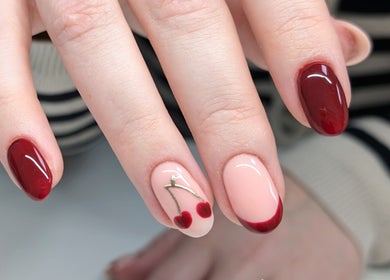 Chic nail art with red cherries at Chloe Hartfield Nail Tech, Burgess Hill, England, GB.