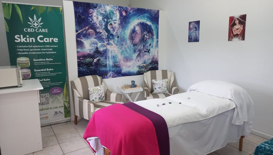 Serene therapy room at Natasja King Reiki and Holistic Wellness in George, Western Cape, ZA. Cozy chairs and massage bed.