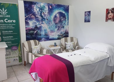 Serene therapy room at Natasja King Reiki and Holistic Wellness in George, Western Cape, ZA. Cozy chairs and massage bed.