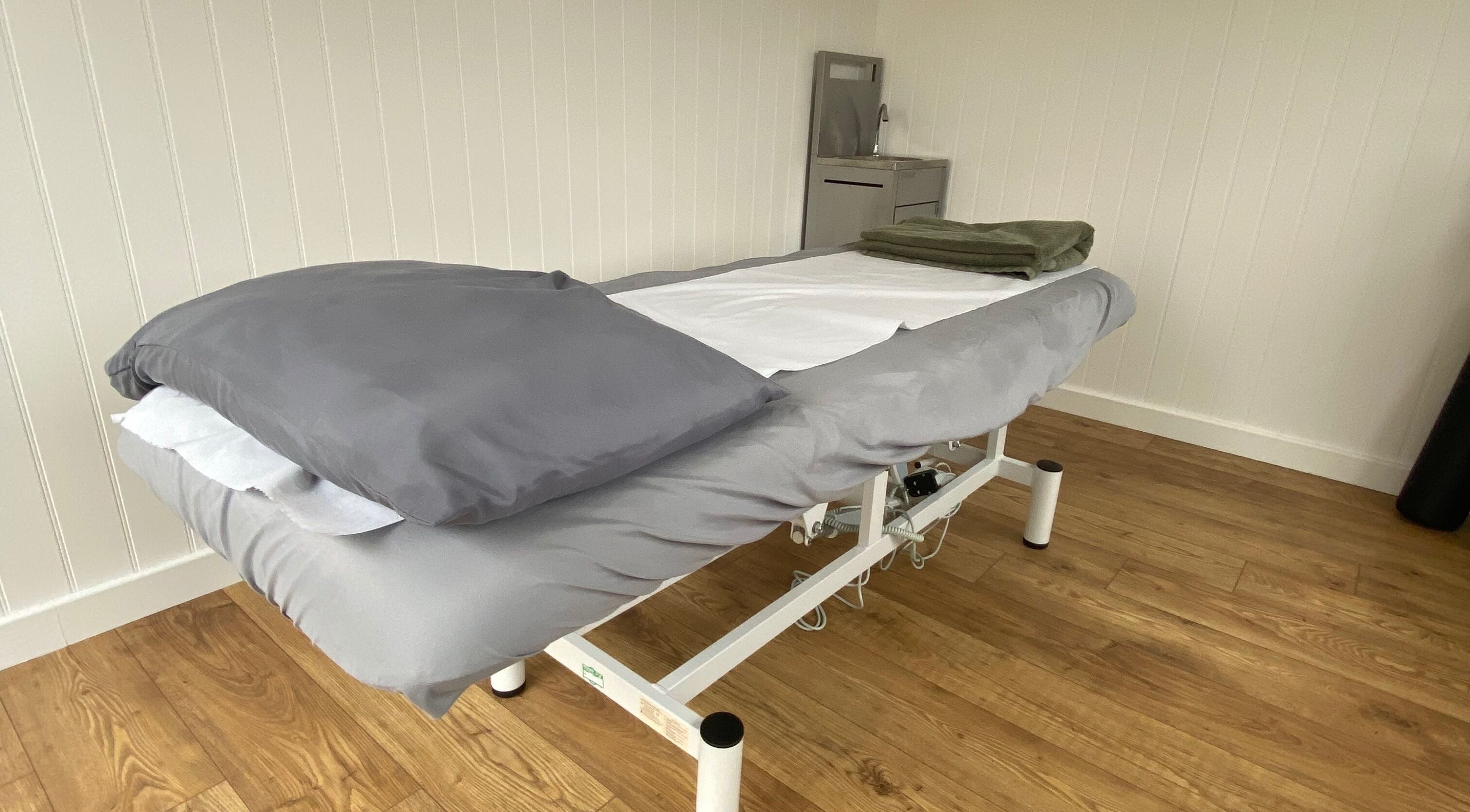 Comfortable massage table at Enhance Sports Massage, Jacksdale, England, GB, ready for relaxation treatments.