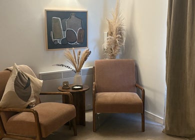 Elegant seating area at Mon Remède Beauty, Bristol, England, GB with armchairs and a decorative vase.