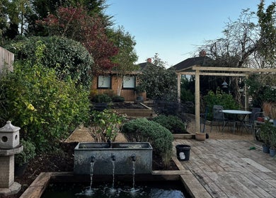 Tranquil garden at Mon Remède Beauty in Bristol, England, GB with lush greenery and a peaceful seating area.