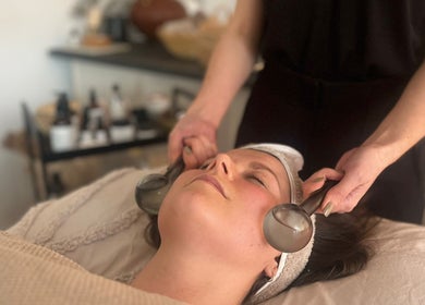 Relaxing facial treatment at Mon Remède Beauty in Bristol, England, GB using soothing therapy tools.